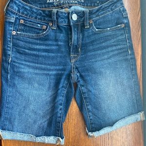American Eagle Midi Blue Cut Off Stretch Shorts in a size 2